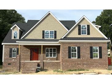 Charming brick home featuring a classic design with a red front door and black shutters at 801 Emmett Ct, Spring Hope, NC 27882