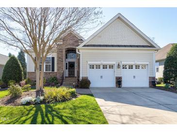 Charming home featuring stone accents, manicured lawn, mature trees, and an attached two-car garage at 11129 Bayberry Hills Dr, Raleigh, NC 27617