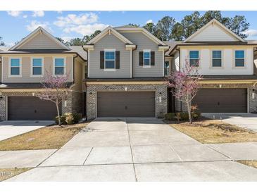 Charming townhome with a brick-accented facade and a well-maintained front yard in a desirable neighborhood at 150 Alamosa Pl, Cary, NC 27519