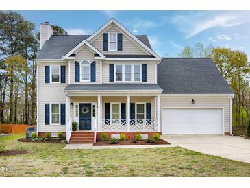 Charming two-story home with blue shutters, a front porch, and a well-manicured lawn at 2020 Battlewood Rd, Apex, NC 27523