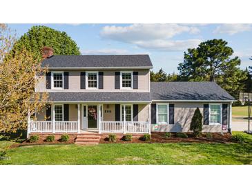 Charming two-story home with a welcoming front porch, black shutters, and a well-maintained lawn at 206 Herronwood Dr, Graham, NC 27253