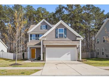 Charming two-story home with a two-car garage and a yellow front door at 250 Hawksbill Dr, Franklinton, NC 27525