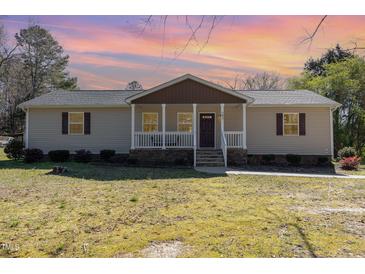 Charming single-story home with a cozy front porch and well-maintained lawn at 297 Lane Store Rd, Franklinton, NC 27525