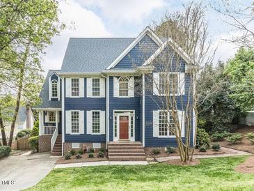 Charming two-story home with blue siding, white shutters, and a well-manicured front lawn at 3100 Anderson Dr, Raleigh, NC 27609
