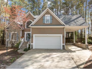 Charming home featuring a large garage, stone accents and a covered carport at 311 Lilliput Ln, Wake Forest, NC 27587