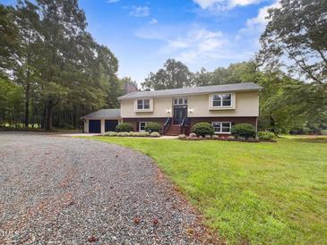 Charming two-story home featuring a spacious front yard and attached two-car garage at 4508 Old Us 421 N, Siler City, NC 27344
