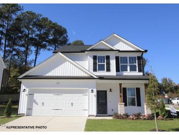 Charming two-story home with a white exterior, black shutters, and a well-manicured lawn at 49 Fetterbush Way, Clayton, NC 27520