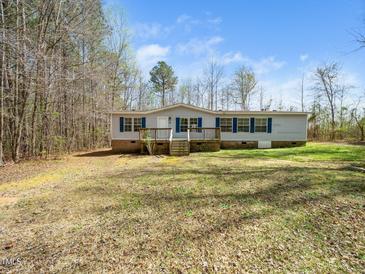 Charming single-level home with a welcoming front porch and well-maintained lawn at 55 J B Rd, Louisburg, NC 27549
