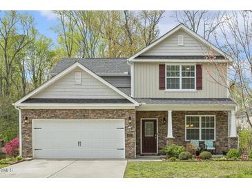 Charming two-story home with stone accents, a two-car garage, and inviting curb appeal at 6021 Watsonia Dr, Zebulon, NC 27597