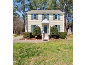 Charming two-story home featuring a well-manicured lawn and inviting curb appeal with blue shutters at 7301 Turtleneck Ct, Raleigh, NC 27616