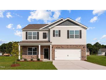 Charming two-story home featuring a brick and siding exterior with a two-car garage at 7750 Michelle Rd, Rocky Mount, NC 27803