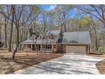 Charming brick home with attached garage and welcoming front porch at 1133 Turner Farms Rd, Garner, NC 27529