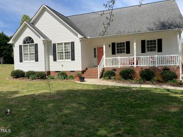 Charming front exterior view with a landscaped yard, porch, and classic architectural details at 126 W Quail Ridge Rd, Oxford, NC 27565