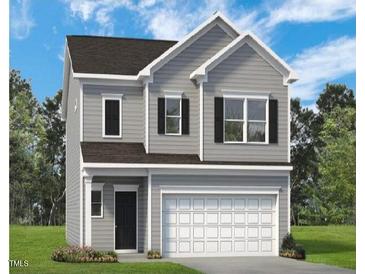 Charming two-story home with gray siding, a two-car garage, and manicured landscaping at 160 Bruce Dr, Dunn, NC 28334