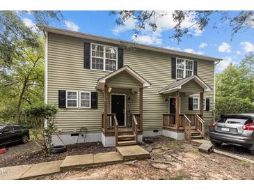Charming two-story home featuring a quaint front porch and neatly maintained landscaping and dark shutters at 204 Allen St # A/B, Creedmoor, NC 27522