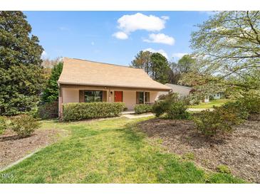 Charming single-story home with a well-maintained lawn, a cozy porch and mature landscaping at 2416 Boothbay Ct, Raleigh, NC 27613