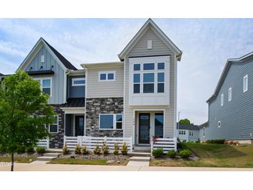 Charming new construction townhome with mixed stone and siding, manicured lawn, and bright curb appeal at 249 Wendover Pkwy, Pittsboro, NC 27312