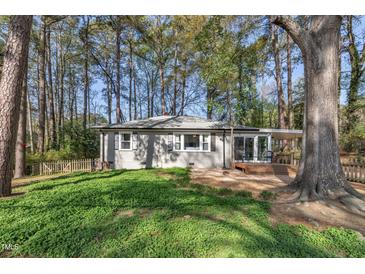 Charming home with a small porch surrounded by lush greenery and mature trees offering a private, serene setting at 3022 Dixon Rd, Durham, NC 27707