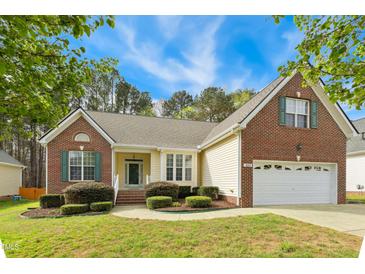 Charming brick and siding home with manicured landscaping, two-car garage and well-maintained lawn at 3213 Kirby St, Durham, NC 27713
