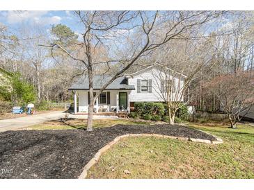 Charming two-story home with front yard landscaping and inviting covered front porch at 7708 Foxwood Dr, Raleigh, NC 27615