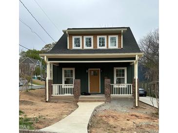 Charming craftsman-style home featuring a covered front porch and inviting curb appeal at 801 N Elm St, Durham, NC 27701