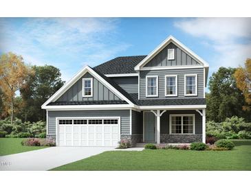 Charming two-story home featuring gray siding, stone accents, an attached garage, and a well-manicured lawn at 937 Thimbleweed Way, Wake Forest, NC 27587