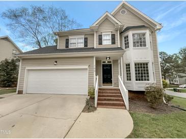 Charming two-story home featuring a garage and well-manicured lawn and a brick stairway to the front door at 100 Ampad Ct, Cary, NC 27513