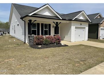 Charming single story home featuring a one-car garage and manicured front lawn at 11 Balboa Pkwy, Clayton, NC 27520