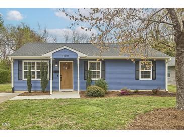 Charming blue home with a well-maintained lawn and manicured landscaping at 1120 N Roxboro St, Durham, NC 27701