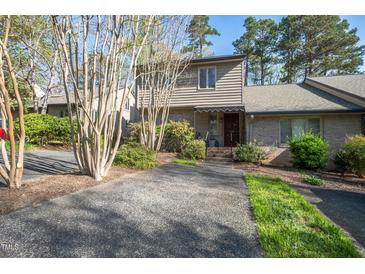 Inviting home with brick and siding, mature landscaping, and a paved driveway at 114 Montrose Dr # 114, Durham, NC 27707