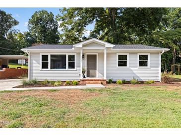 Charming single-story home featuring a well-maintained lawn and inviting front porch at 122 W Union St, Hillsborough, NC 27278