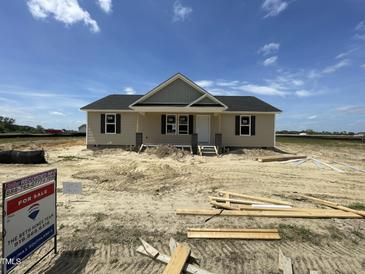 Charming, new construction single-Gathering home featuring neutral siding and a classic roofline at 129 Grace Pond Ave, Benson, NC 27504