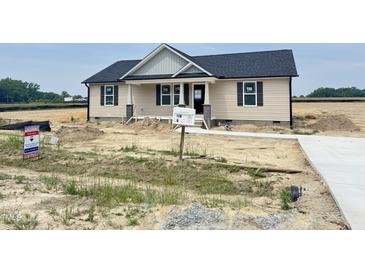 Charming single-story home featuring a covered porch and newly installed siding, walkway, and mailbox at 129 Grace Pond Ave, Benson, NC 27504