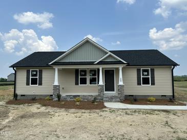 Charming single-story home with a covered front porch and stone accents at 129 Grace Pond Ave, Benson, NC 27504