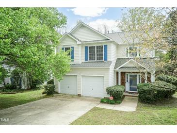 Charming two-story home with a two-car garage, manicured lawn, and mature trees at 206 Newberry Ln, Durham, NC 27703