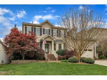 Charming two-story home featuring a manicured lawn and inviting front porch at 317 Briarfield Dr, Apex, NC 27502