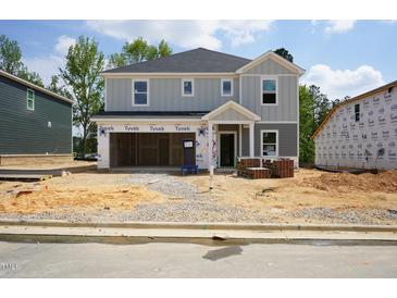 Two-story home with attached two-car garage in the process of being built at 3857 Rosebush Dr, Zebulon, NC 27597