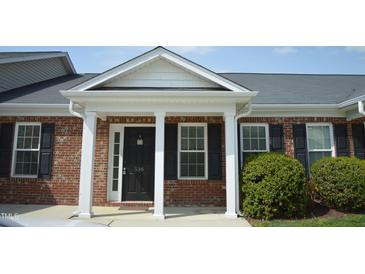Charming brick home with a covered front entrance, white columns, and black shutters, creating a welcoming curb appeal at 536 Dearing Dr, Haw River, NC 27258