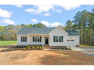 Charming single-story home with classic white siding, black shutters, and a well-manicured front yard at 9550 Stallings Road Rd, Spring Hope, NC 27882