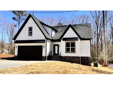 Beautiful new construction with black windows and a modern farmhouse aesthetic at 120 Sequoia Dr, Louisburg, NC 27549