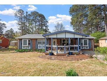 Charming single-story brick home with a cozy front porch and well-maintained landscaping at 1800 Tee Dee St, Raleigh, NC 27610