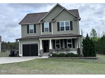 Charming two-story home with a covered front porch and well-maintained lawn at 194 Cornfield Ln, Benson, NC 27504