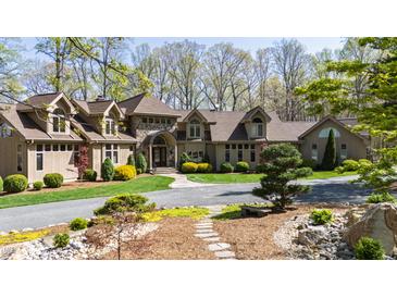Impressive home featuring manicured landscaping, stone accents, and a welcoming entrance, all set in a mature treed lot at 301 Stone Currie Dr, Hillsborough, NC 27278