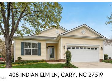 Charming single-story home with a two-car garage, manicured lawn, and inviting front entrance at 408 Indian Elm Ln, Cary, NC 27519