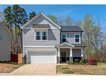 Charming two-story home with a gray shingle facade, attached garage, and well-maintained landscaping at 433 Mockingbird Ln, Mebane, NC 27302