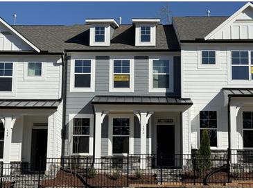 Charming two-story home with gray siding and a black iron fence at 480 Traditions Grande Blvd # 31, Wake Forest, NC 27587