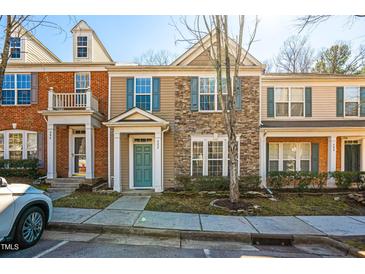 Charming townhome with stone accents, neutral siding, and blue shutters at 602 Walnut Woods Dr # 62, Morrisville, NC 27560