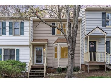 Charming townhouse featuring vinyl siding, shuttered windows, and a cozy front porch at 6734 Chauncey Dr, Raleigh, NC 27615