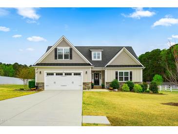 Charming single-Gathering home with a well-manicured lawn, attached two-car garage, and inviting front entrance at 81 N Lumina Ln, Clayton, NC 27527