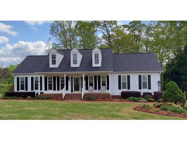 Charming single-story home with a welcoming front porch and beautiful landscaping at 117 Linwood Ln, Clayton, NC 27527